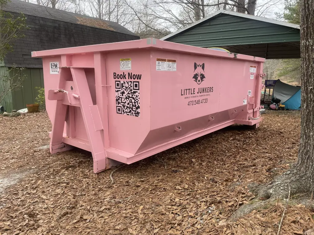 The Little Junker 11 yard dumpsternear a carport