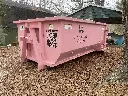 The Little Junker 11 yard dumpsternear a carport